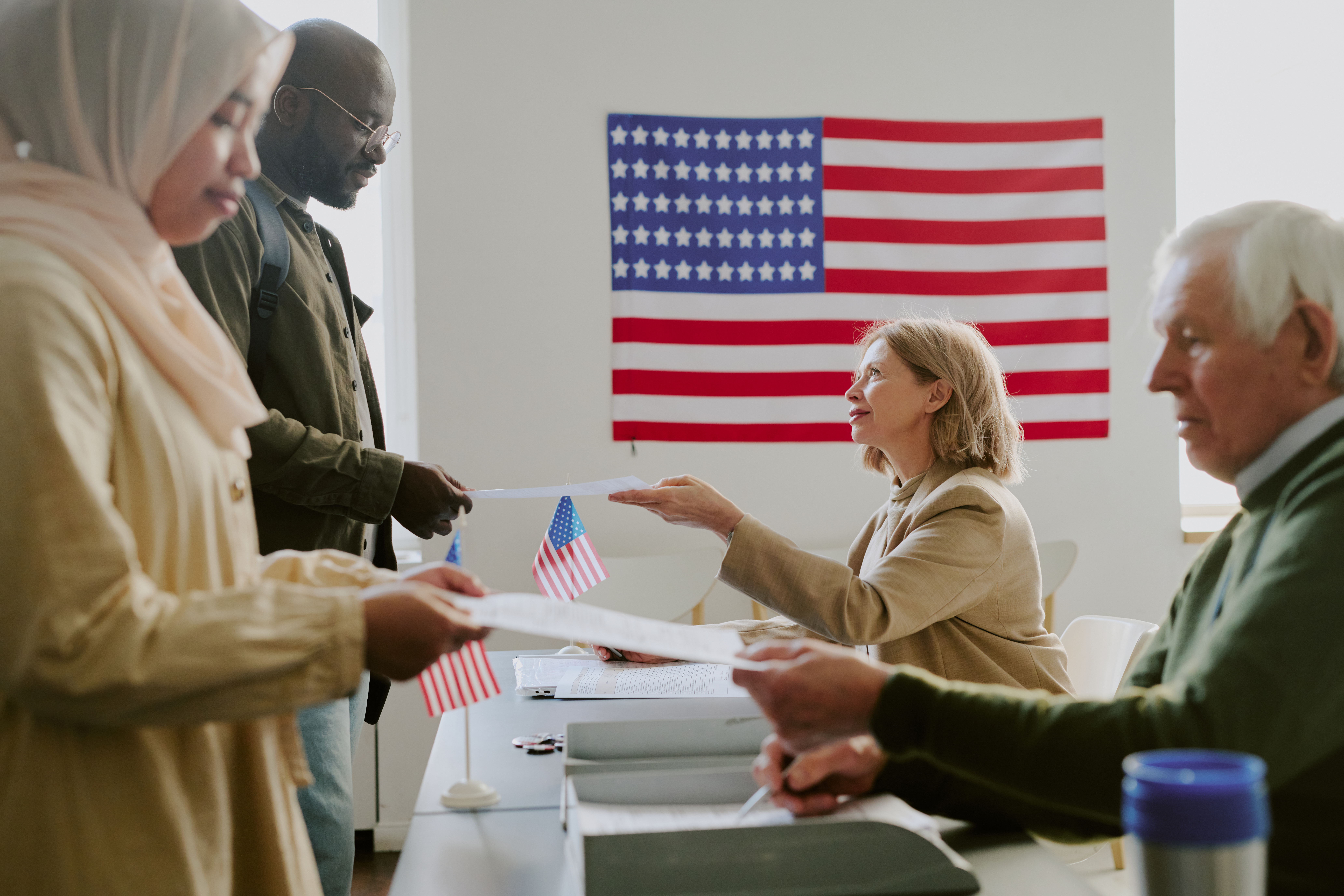 voting station workers giving papers to citizens 2024 06 20 19 01 51 utc